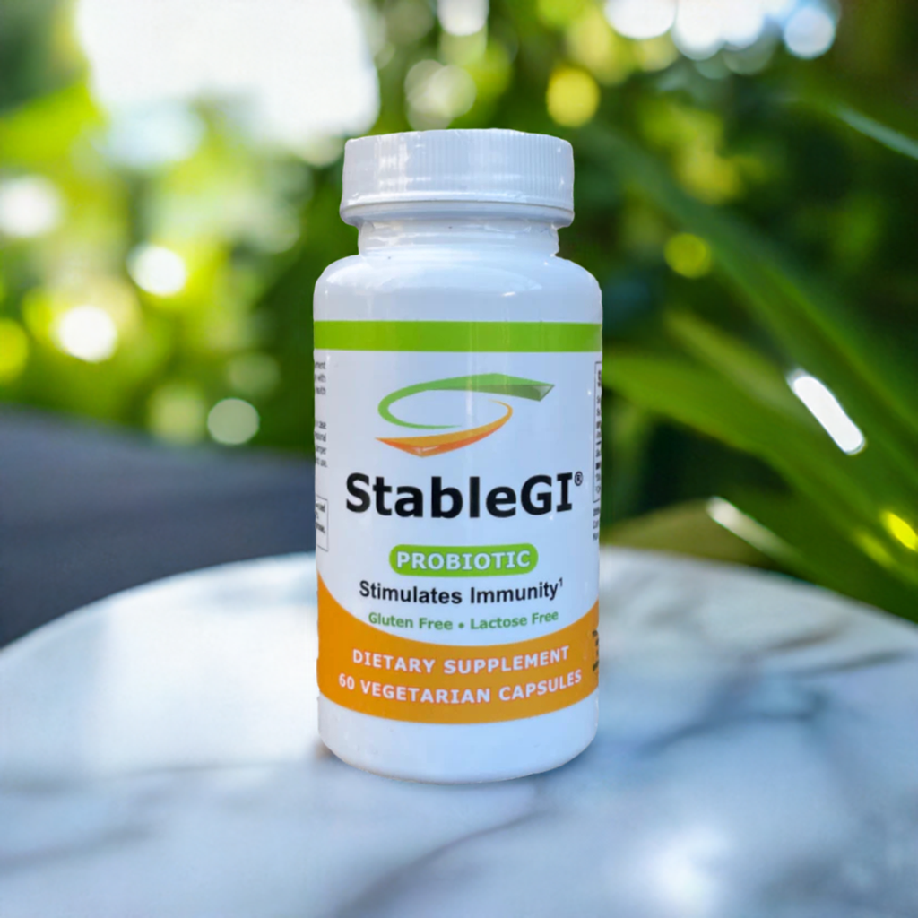 StableGI probiotic dietary supplement bottle with 60 lactose-free and gluten-free vegetarian capsules on a marble surface outdoors